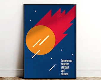 May include: A framed art print with a minimalist design. It features an orange circle with white lines, a red comet-like shape, and the text "Somewhere between stardust and silence" on a dark blue background. White dots represent stars.