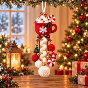 May include: A crocheted Christmas ornament featuring a red mug filled with white marshmallows and a candy cane, decorated with a white snowflake. Below the mug hangs a white spiral, a large white pom-pom, and smaller red and white ornaments.