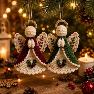 May include: Two handmade crochet angel ornaments hanging by strings. One angel wears a deep red dress, the other a dark green dress. Both have cream-colored heads with gold halos, cream wings with red or green stitching, and holly berry accents.