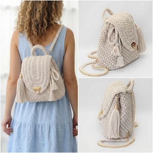 May include: Cream-colored crochet backpack with a flap closure, gold-tone hardware, and a tassel. The bag has a top handle and adjustable straps. The bag is shown on a person wearing a blue dress.