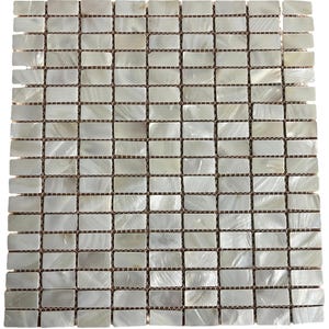 May include: A square mosaic tile sheet composed of numerous rectangular tiles. Each tile has a pearlescent, off-white finish, arranged in a grid pattern. The tiles are mounted on a brown cardboard backing, creating a textured appearance.