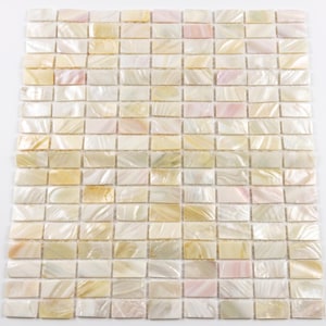 May include: A rectangular mosaic tile sheet composed of numerous small, iridescent tiles. The tiles display a range of colors, including white, cream, pale pink, and gold, creating a shimmering effect. The tiles are arranged in a grid pattern.