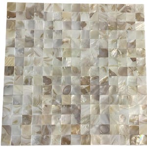 May include: A square mosaic tile sheet composed of small, individual square pieces of iridescent mother-of-pearl. The tiles feature a natural color palette of cream, beige, soft white, and light brown, with a reflective, pearlescent surface finish.