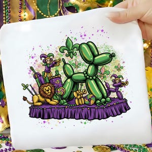 May include: A white ceramic mug with a black handle and the text "But First, Coffee" in a black, bold font. The mug is on a white surface. The mug is approximately 10 cm tall.