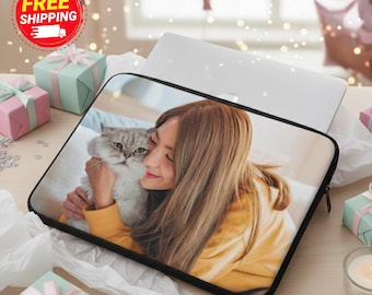 May include: Laptop sleeve featuring a photograph of a person hugging a gray and white cat. The sleeve is black with a zipper closure. The image is surrounded by gift boxes and decorative elements.
