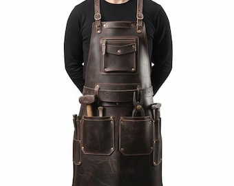 May include: A brown leather apron with multiple pockets and tool holders. The apron has adjustable straps and a front pocket with a zipper. Tools, including a hammer and pliers, are visible in the pockets.