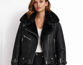 May include: Black leather jacket with a shearling collar and lining. The jacket features a classic biker style with a zip closure, multiple pockets, and buckle details on the cuffs and waist. A stylish outerwear piece.