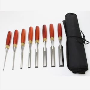 May include: A set of eight wood chisels with polished wooden handles and metal blades. The chisels are arranged in a row, with a black fabric roll-up case on the right side. The chisels vary in size and blade shape, suitable for woodworking.