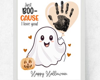 May include: A framed Halloween-themed print featuring a smiling white ghost holding a pumpkin. A handprint in a heart-shaped balloon floats above the ghost. The text reads "Just BOO-CAUSE I love you!" and "Happy Halloween."