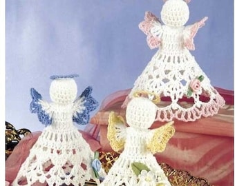 May include: Three crocheted angel ornaments with white lace dresses and haloes. The angels have blue, pink, and yellow accents on their dresses.