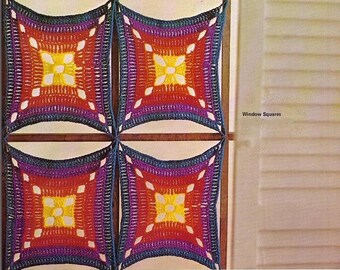 May include: Four crocheted squares in shades of purple, red, yellow, and orange, with a white flower design in the center of each square. The squares are attached to a wooden frame, creating a window-like design. The text "Window Squares" is visible in the image.