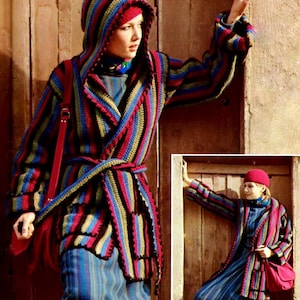 May include: A striped crocheted hooded cardigan with a long tie belt. The cardigan is in shades of blue, green, pink, and black. The model is wearing a matching striped skirt.