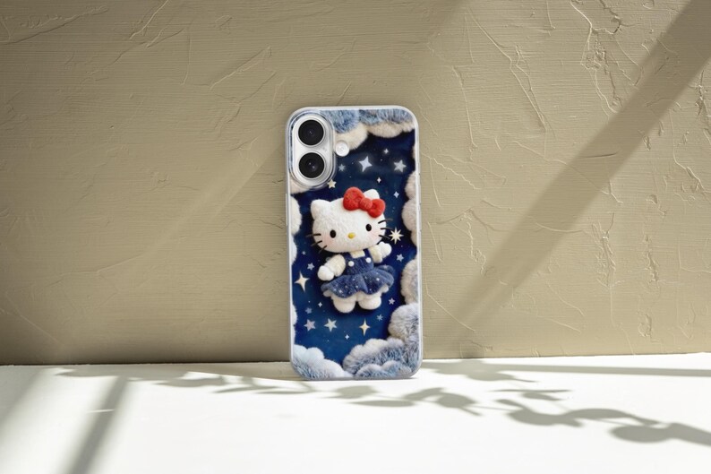 May include: A phone case featuring a 3D Hello Kitty design. The case has a blue starry night background with white clouds and a white Hello Kitty wearing a blue dress and a red bow. The case is designed for a smartphone.