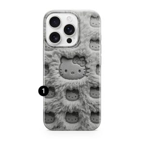May include: A gray phone case with a fuzzy texture and embossed Hello Kitty faces. The case has a large Hello Kitty face in the center and smaller faces scattered across the surface. The camera lenses are visible at the top.