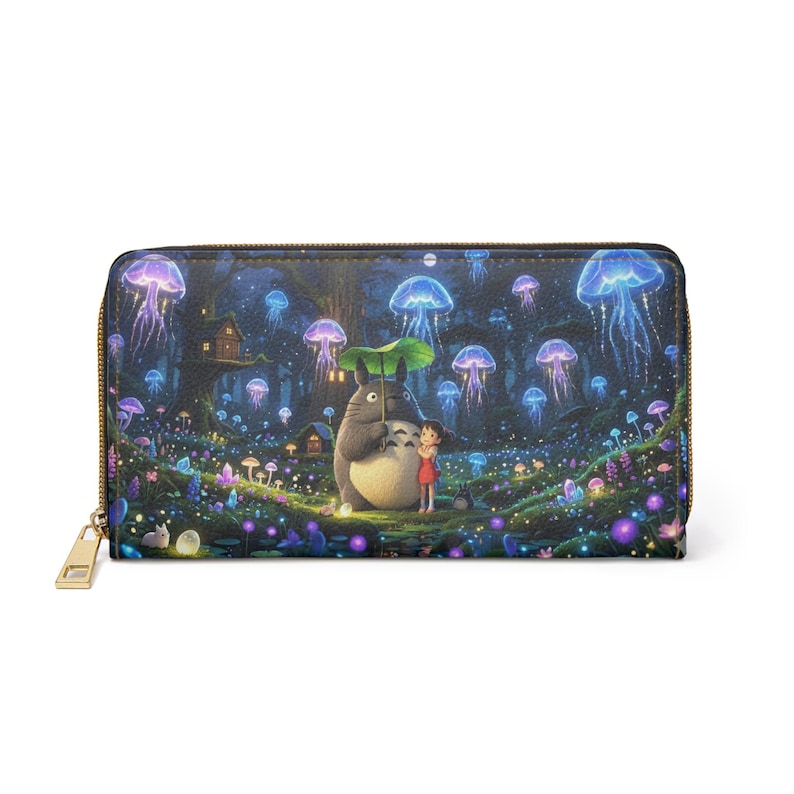 May include: A zip-around wallet with a fantasy forest scene featuring glowing jellyfish, mushrooms, and a cartoon character under an umbrella. The wallet has a gold-coloured zip and a detailed, colourful design.