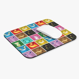 May include: A rectangular mousepad featuring a colorful grid pattern of various cartoon characters. A white wireless mouse rests on the pad. The characters are set against a variety of colored squares, including red, yellow, blue, and black.