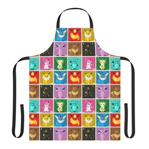 May include: A black apron with a repeating pattern of colorful cartoon characters in square blocks. The apron has a black neck strap and black waist ties. The characters are in various colors including blue, yellow, red, and brown.