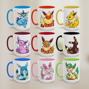 May include: Eleven white ceramic mugs with coloured interiors and handles. Each mug features a different cartoon character design. The mugs display a variety of colours, including blue, orange, yellow, purple, brown, black, pink, and green.