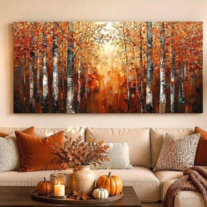 May include: A rectangular canvas wall art piece depicting a dense forest scene with tall birch trees and vibrant orange, red, and yellow autumn foliage. The painting features a warm, glowing light filtering through the trees with textured brushstrokes.