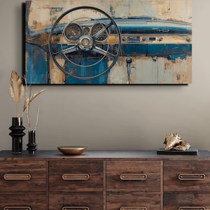 May include: An abstract painting of a classic car dashboard, with a steering wheel, dials, and a blue and beige palette. The artwork is displayed above a wooden chest of drawers with decorative items.