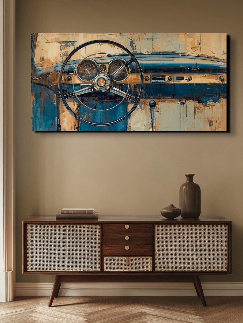 May include: An abstract painting of a classic car dashboard. The artwork features a black steering wheel, chrome gauges, and a blue and beige colour palette. The painting is displayed above a wooden cabinet with woven panels.