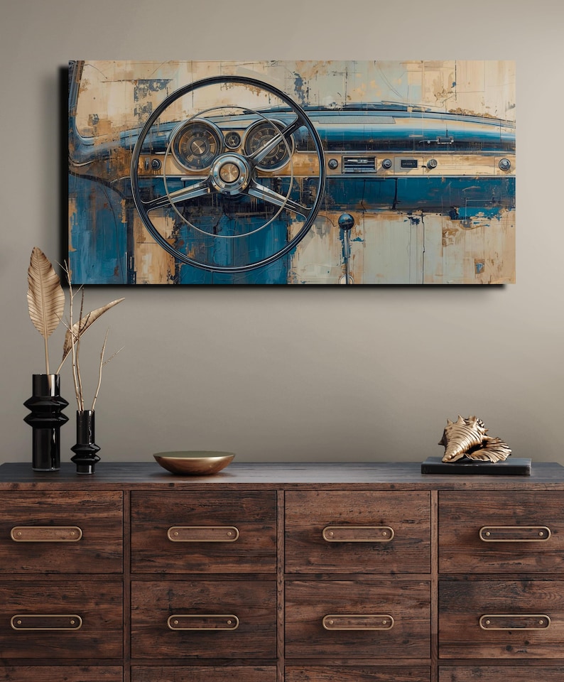 May include: An abstract painting of a classic car dashboard, with a steering wheel, dials, and a blue and beige palette. The artwork is displayed above a wooden chest of drawers with decorative items.