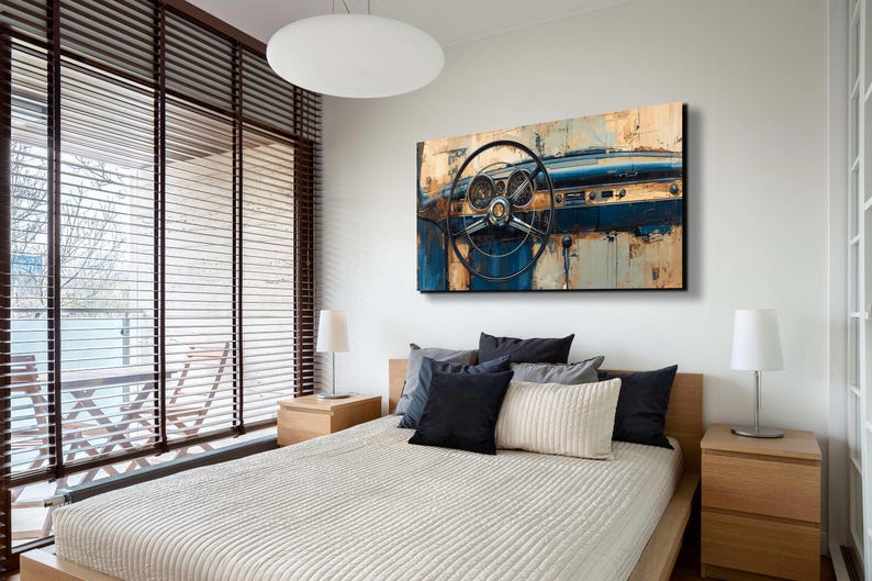 May include: An abstract painting of a classic car dashboard and steering wheel. The artwork features a colour palette of blue, brown, and beige, with visible gauges and a detailed steering wheel. The painting is mounted above a bed with pillows.