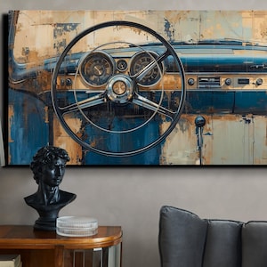May include: Abstract art print of a classic car dashboard. The artwork features a steering wheel, gauges, and a blue and tan colour palette. The painting is displayed on a wall above a wooden table with a lamp and a bust.