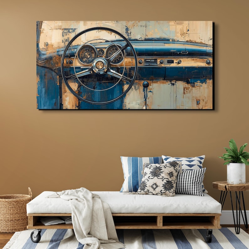 May include: A rectangular wall art print featuring a vintage car dashboard in shades of deep blue and weathered tan. The image displays a large circular steering wheel centred over a dashboard with round gauges, knobs, and a radio panel.
