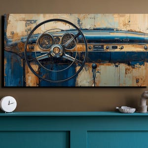 May include: A rectangular wall art print depicting the interior dashboard and steering wheel of a vintage car. The artwork features a distressed, weathered aesthetic with a colour palette of deep blue, muted gold, and brown tones.