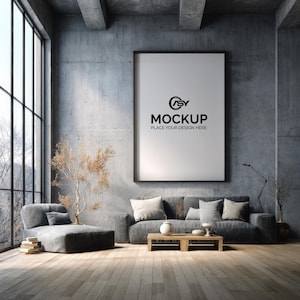 May include: A modern living room with a large framed mockup on the wall. A gray sofa with pillows and a chaise lounge are in front of a large window. The mockup reads "MOCKUP PLACE YOUR DESIGN HERE".