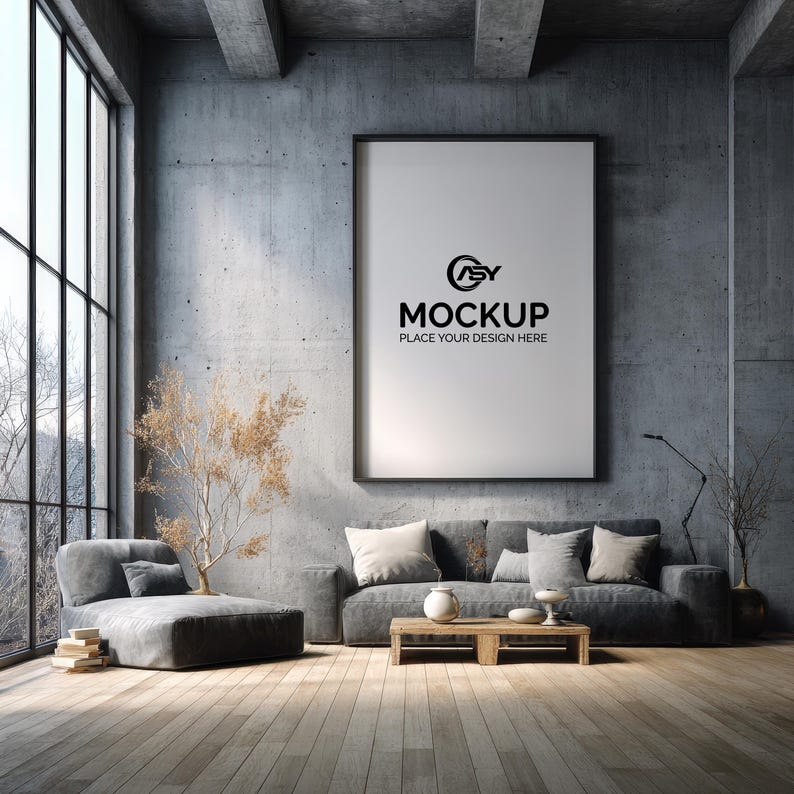 May include: A modern living room with a large framed mockup on the wall. A gray sofa with pillows and a chaise lounge are in front of a large window. The mockup reads "MOCKUP PLACE YOUR DESIGN HERE".