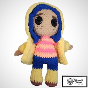 May include: A handmade crochet doll featuring a character with blue hair, large black button eyes, and a yellow hooded jacket. The doll wears a pink and orange striped shirt, blue pants, and yellow boots. The doll is approximately 12 inches tall.