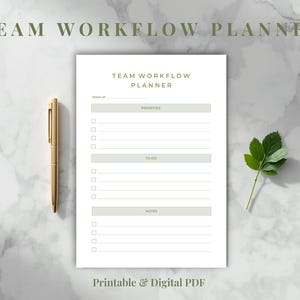 May include: A white Team Workflow Planner with sections for projects, to-dos, and notes. A gold pen rests beside the planner on a marble surface. The text "Printable & Digital PDF" is at the bottom. A sprig of green leaves is on the right.