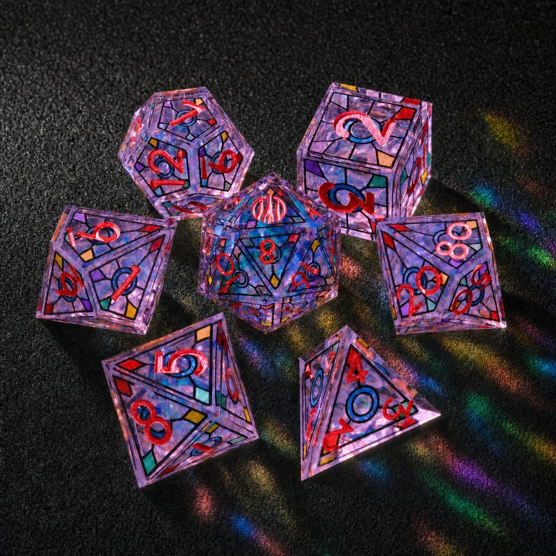 May include: A set of seven polyhedral dice featuring a translucent purple base with a stained-glass pattern of black lines and colorful geometric shapes. Each die has bright red numbers etched into the surface, creating a vibrant contrast.