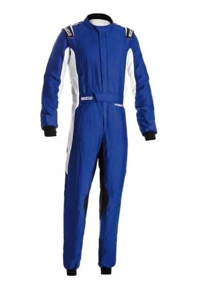 May include: A blue racing suit with white and black accents. The suit has a high collar, long sleeves, and a belt at the waist. The shoulders have white patches with black text. The suit is designed for motorsports.