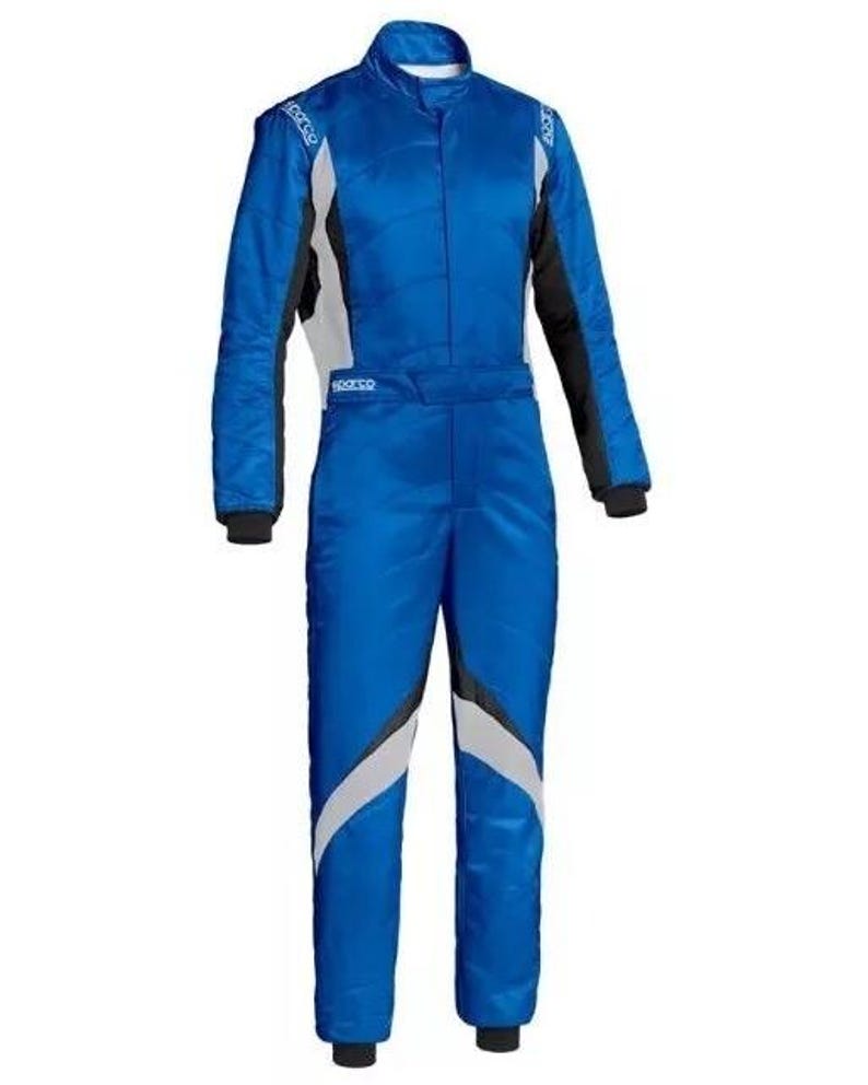 May include: A blue racing suit with white and black accents. The suit has a high collar, long sleeves, and a full-length zipper. The suit has the word "Sparco" printed on the chest and shoulders. The suit is designed for motorsports.