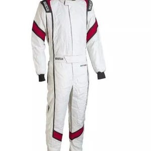 May include: White racing suit with black and red accents. The suit features a stand-up collar, long sleeves, and a front zipper. The Sparco logo is visible on the shoulders and chest. The suit has black cuffs and red stripes on the shoulders and legs.