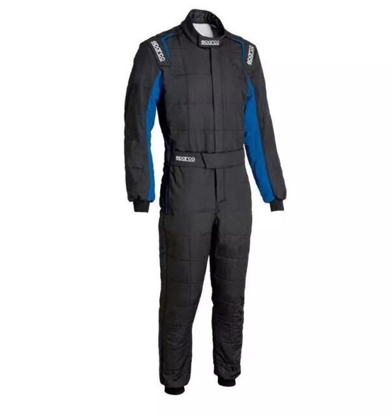May include: Black racing suit with blue accents on the shoulders and arms. The suit has a quilted design and a belt at the waist. The Sparco logo is visible on the shoulders and chest.