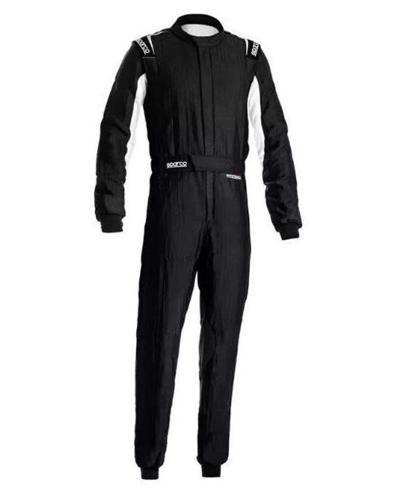 May include: Black racing suit with white accents on the shoulders and sleeves. The suit has a high collar and a belt around the waist. The brand name "Sparco" is visible on the shoulders and belt.