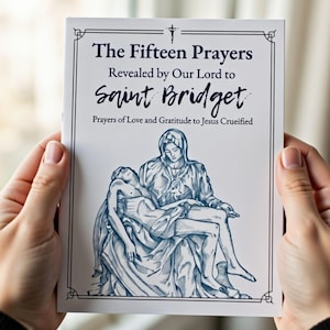 May include: A booklet titled "The Fifteen Prayers Revealed by Our Lord to Saint Bridget." The cover features a blue and white illustration of a religious scene, with text in a decorative frame. The booklet is held by two hands.