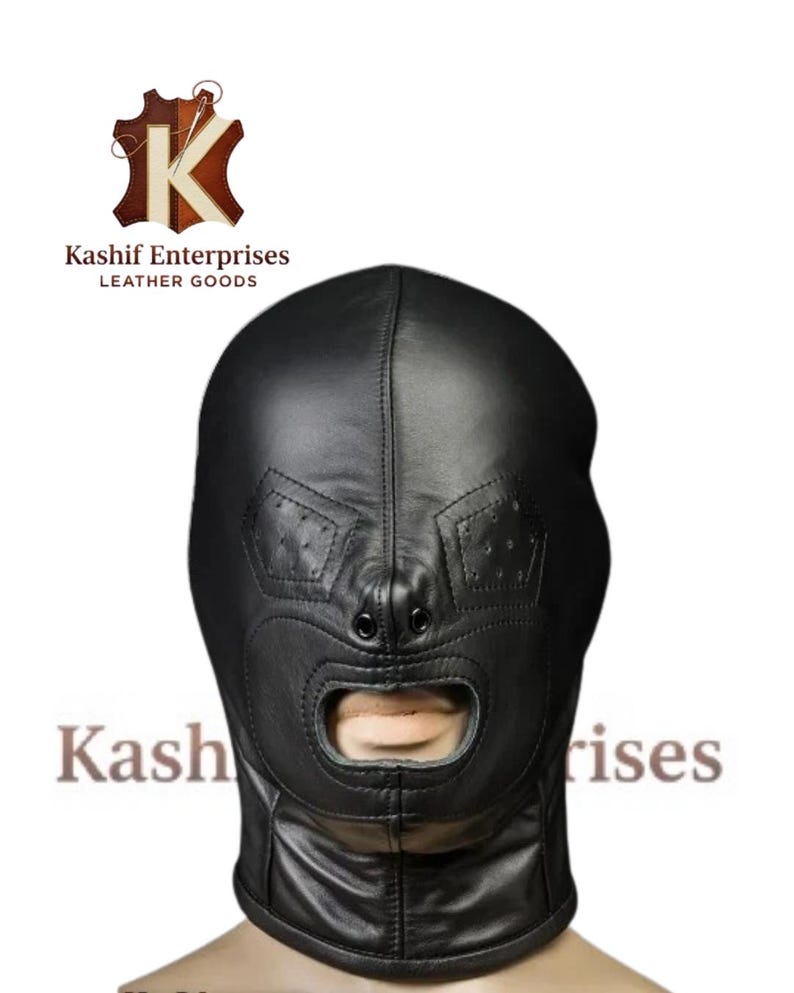 May include: Black leather hood with an open mouth and eye design. The hood has stitched details and a smooth texture. The text "Kashif Enterprises Leather Goods" is visible.