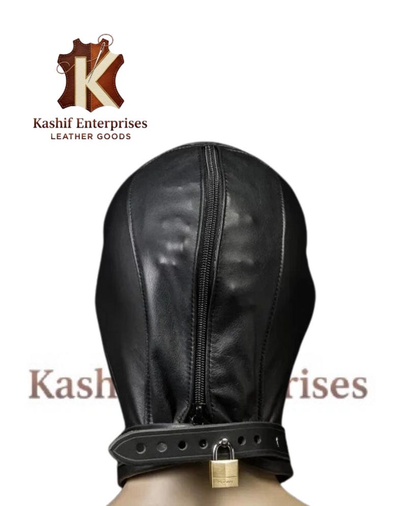 May include: Black leather hood with a full head and neck covering, featuring a vertical zipper and a buckled collar secured with a padlock. The logo "Kashif Enterprises LEATHER GOODS" is visible.