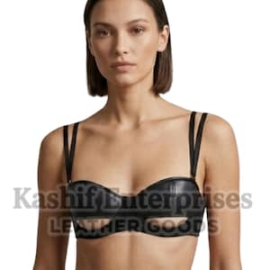 May include: Black leather bra with a cut-out design. The bra features thin, adjustable straps and a structured silhouette. The image shows the bra on a person, highlighting its shape and details. The text "Kashif Enterprises LEATHER GOODS" is visible.