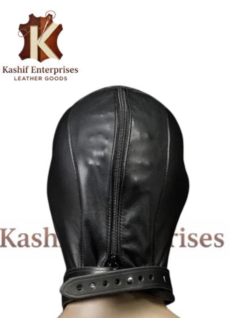 May include: Black leather hood with a full head and neck coverage. The hood features a vertical zipper down the front and a buckled strap around the neck. The product is from Kashif Enterprises Leather Goods.