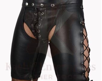 May include: Black leather shorts with a lace-up design on the sides and front. The shorts feature a high waist with silver rivets and a zipper closure. The garment has open areas on the front and sides.