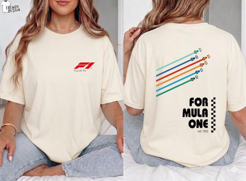 Pu&ograve; includere: Una t-shirt a maniche corte color crema con un piccolo logo rosso Formula 1 sul petto. Il retro mostra una grafica di cinque auto da corsa colorate con linee di velocit&agrave; diagonali e il testo Formula One est. 1950 con un bordo a scacchi.