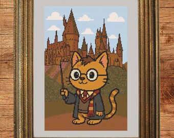 May include: A framed cross-stitch design of a cartoon cat in glasses, scarf, and robe, holding a wand, with a castle backdrop under a blue sky. The gold-coloured frame surrounds the image, which includes the text "Instant Download PDF".