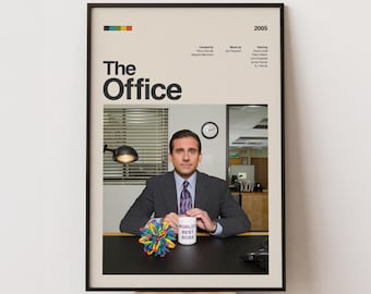 May include: Framed poster featuring the title "The Office" with a photo of Michael Scott. The poster includes the year 2005 and credits. A "World's Best Boss" mug and a colorful ball are on the desk. The poster is in a black frame.