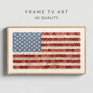 May include: A framed artwork depicting the American flag, crafted from small, colorful flowers. The flag's design is meticulously recreated with blue, red, and white blossoms, set against a neutral background. The frame is a light wood color, and the text "FRAME TV ART 4K QUALITY" is at the top.